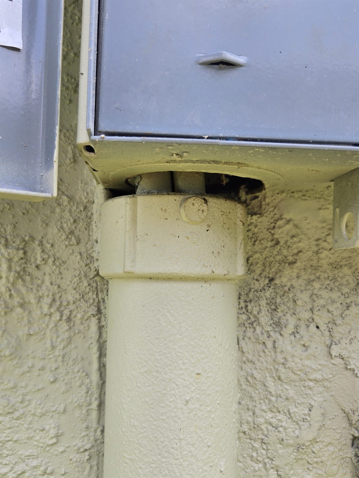 Electrical conduit pulled away from the bottom of an exterior disconnect enclosure, conductors exposed