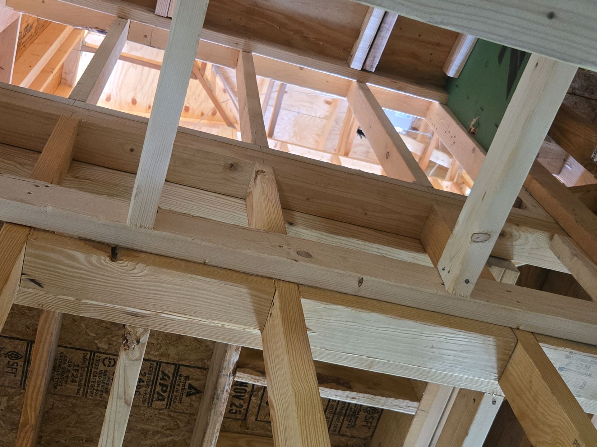 Wood framing between two floors at pre-drywall where the hurricane straps are missing