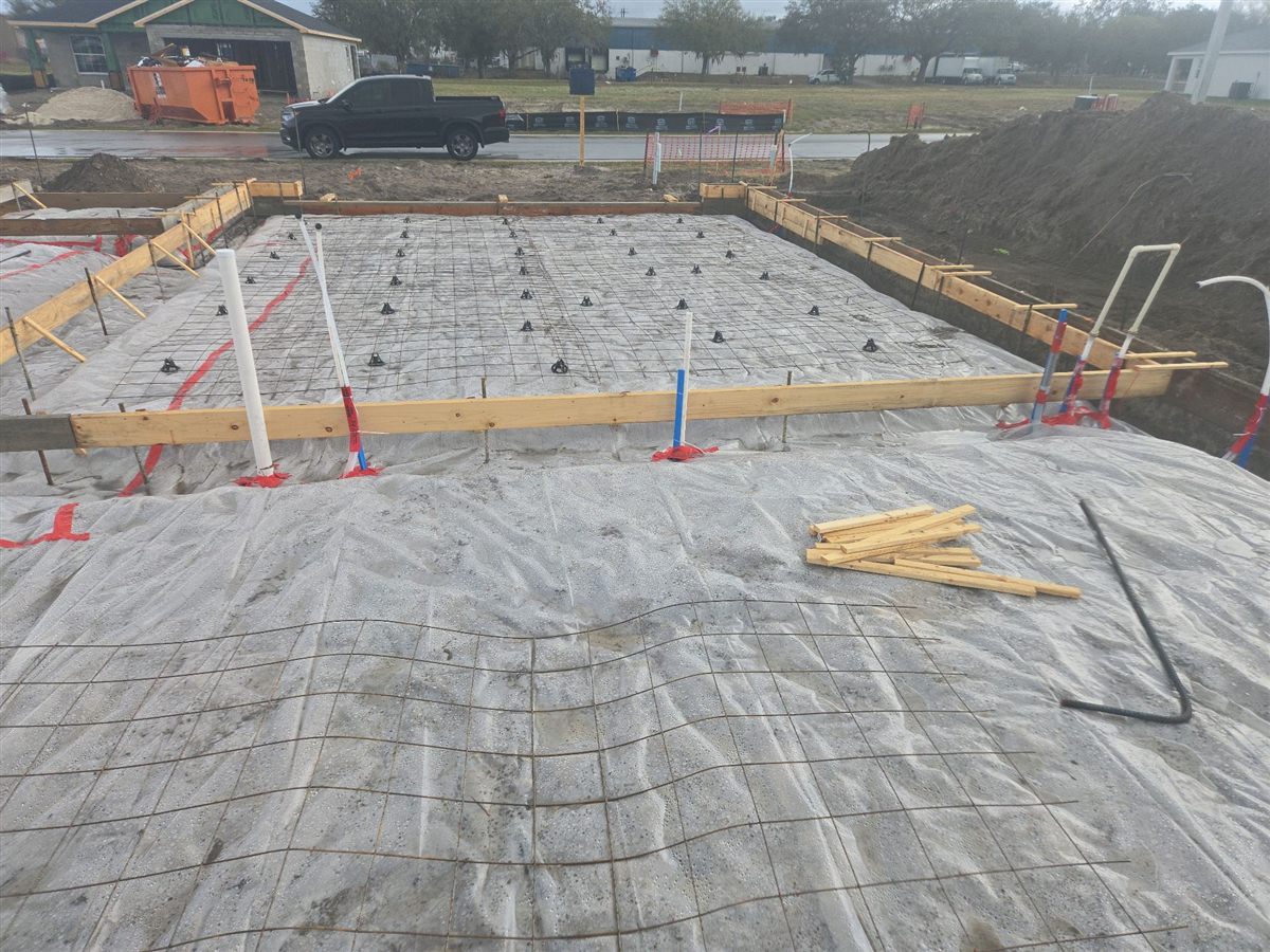 Lumber offcuts left on the vapor barrier inside the forms