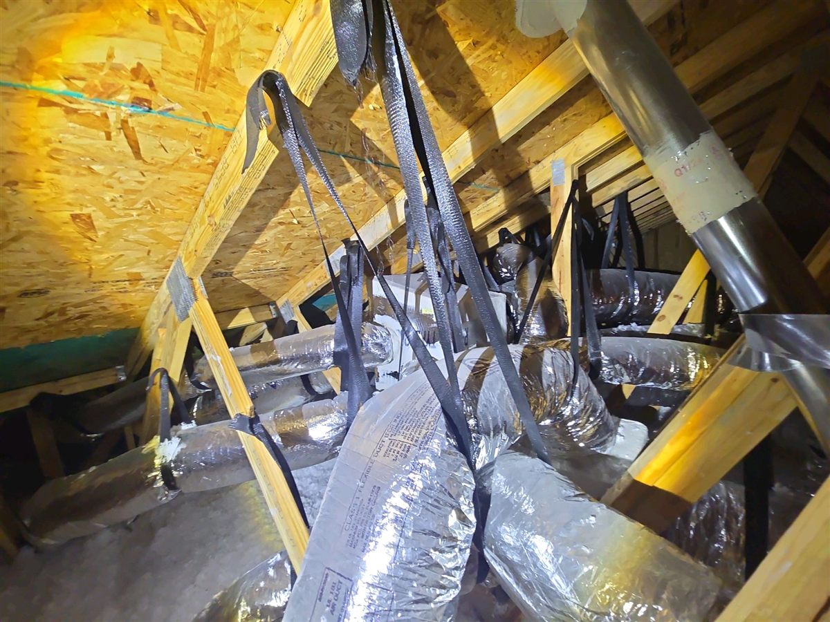 Flex ducts crushed against the trusses and each other in the attic