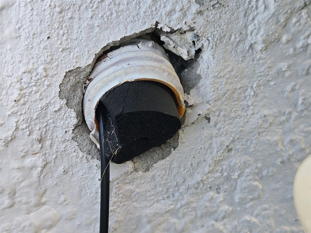 A pipe through the stucco with the opening around it left unsealed